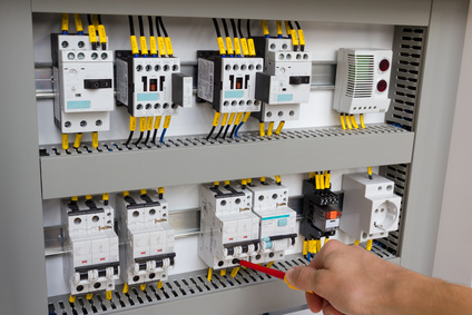 Technician working at electrical cabinet